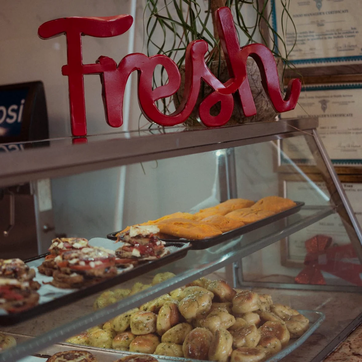 Fresh garlic knots and prepared food at the Victorious counter