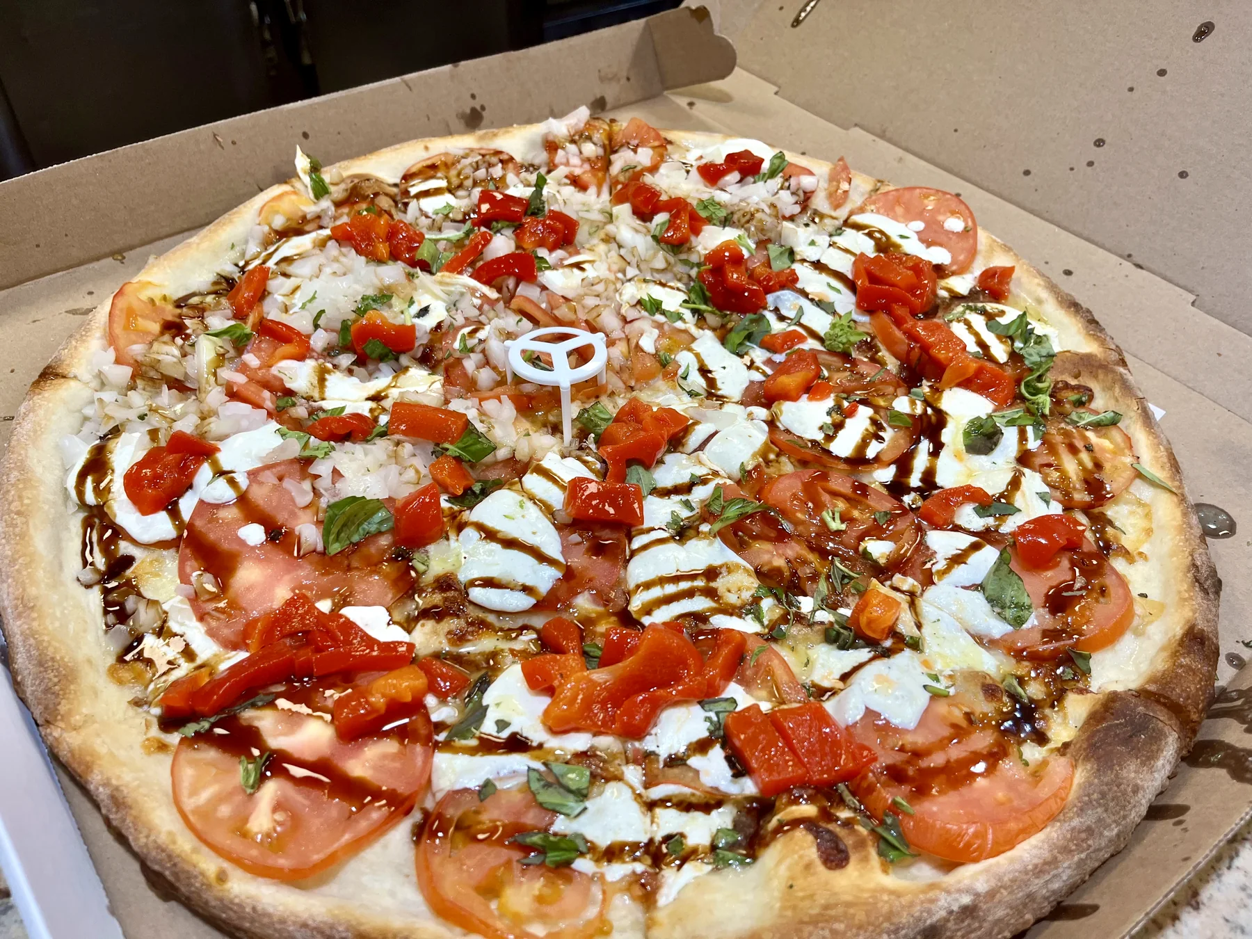 Fresh mozzarella, tomato and roasted pepper pizza made at Victorious